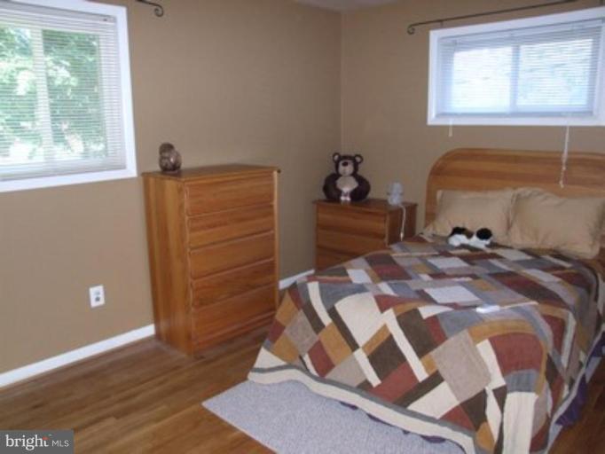 3719 Astoria Road Kensington, MD 20895 - Photo 15 of 19 a bed sitting in a bedroom next to a window