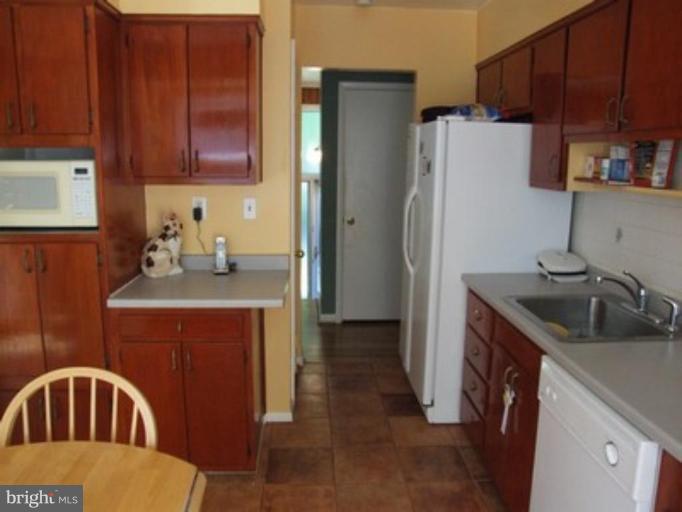 3719 Astoria Road Kensington, MD 20895 - Photo 9 of 19 a kitchen with stainless steel appliances granite countertop a refrigerator a sink and dishwasher