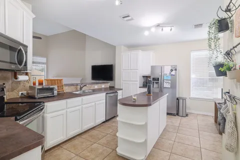 a kitchen with a sink and white cabinets