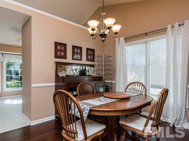 12204 Inglehurst Drive Raleigh, NC 27613 - Photo 4 of 14 a view of a dining room with furniture window and wooden floor