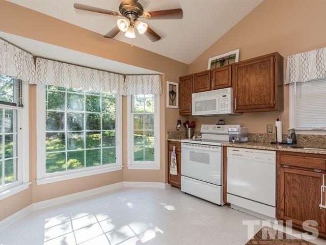 12204 Inglehurst Drive Raleigh, NC 27613 - Photo 5 of 14 a kitchen with stainless steel appliances a stove a sink and a refrigerator
