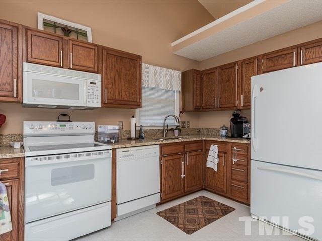 12204 Inglehurst Drive Raleigh, NC 27613 - Photo 6 of 14 a kitchen with a stove sink and cabinets