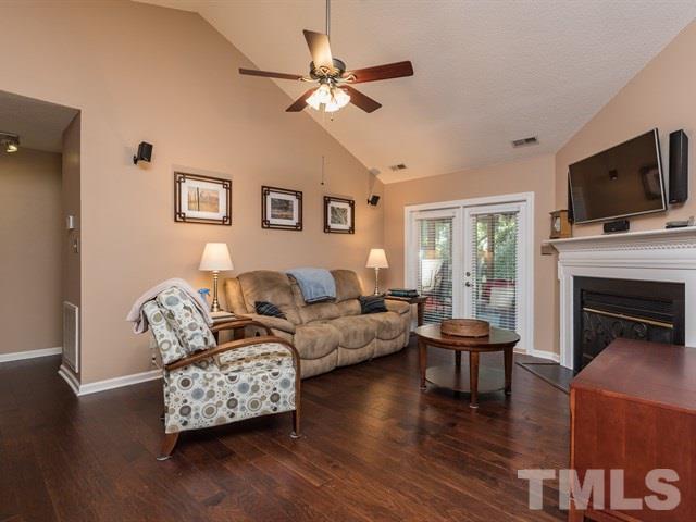 12204 Inglehurst Drive Raleigh, NC 27613 - Photo 7 of 14 a living room with furniture fireplace and a flat screen tv