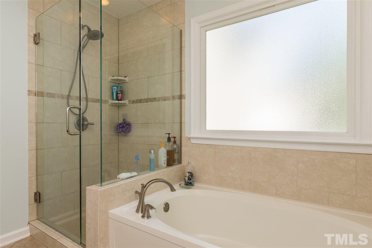 12204 Inglehurst Drive Raleigh, NC 27613 - Photo 10 of 14 a white bath tub sitting next to a window
