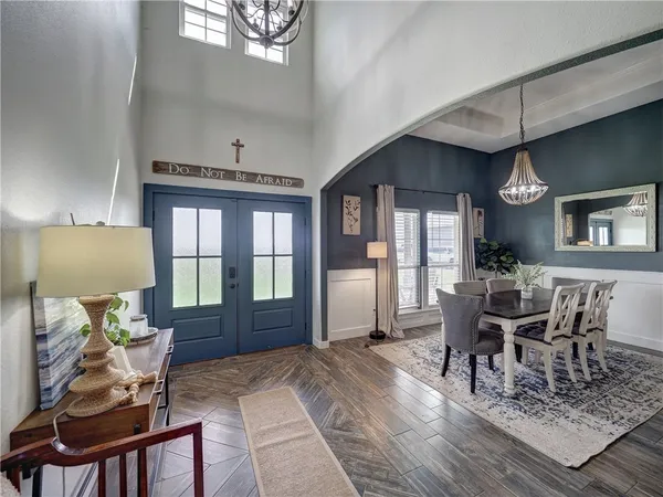 a living room with furniture a fireplace and a table