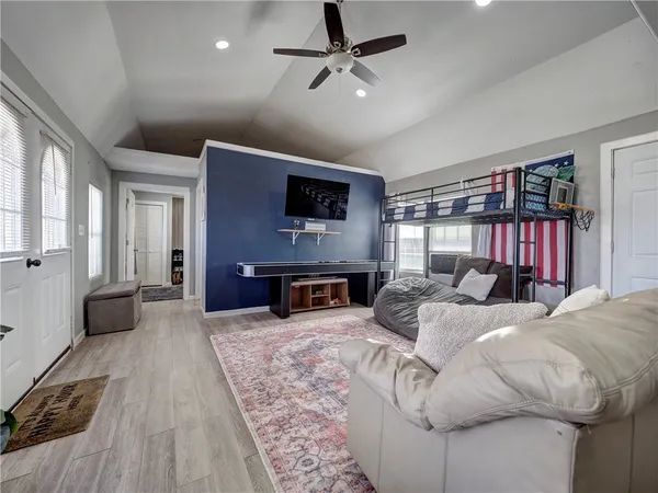 a bedroom with a bed and a tv on table