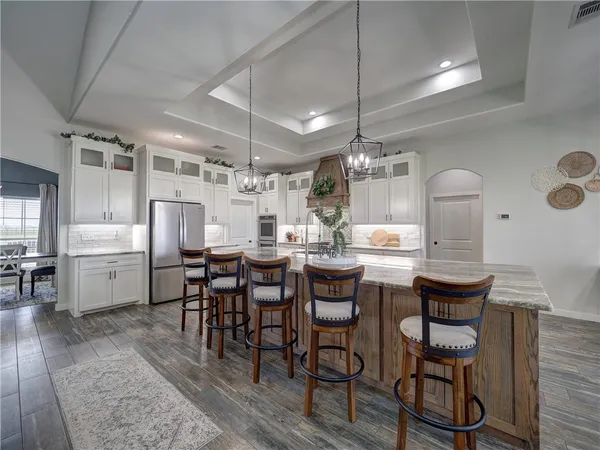 a kitchen with cabinets and chairs in it