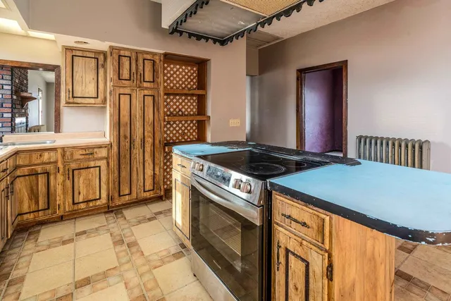 a kitchen with a stove top oven and cabinets