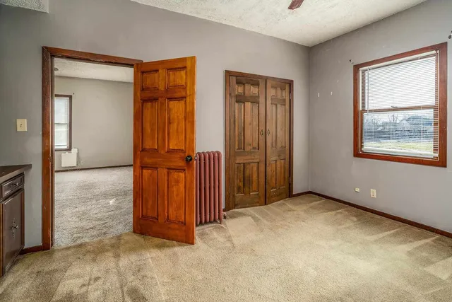 an empty room with windows and closet