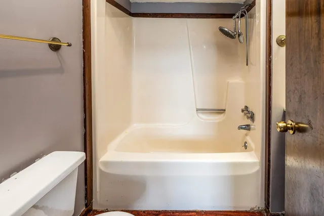 a bathroom with a bathtub and a shower