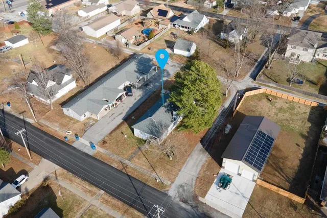 an aerial view of a house with a yard