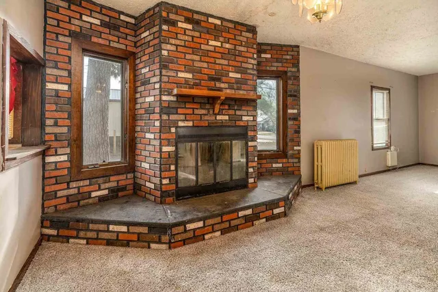 a living room with furniture pool table and a fireplace
