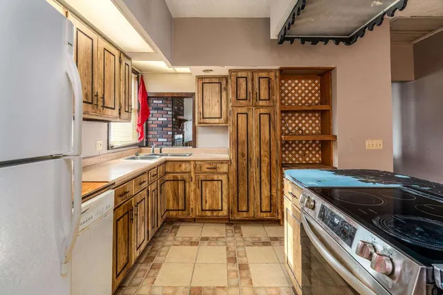 a kitchen that has a sink and a stove