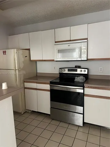 a kitchen with a stove and a refrigerator