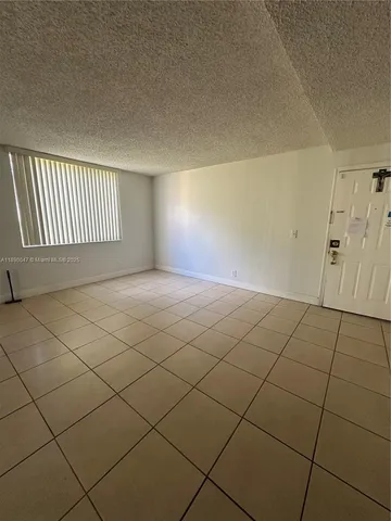 a view of an empty room and a window