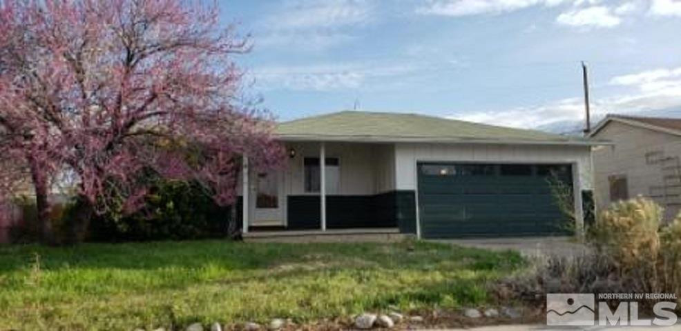 1020 Stewart Street Reno, NV 89502 - Photo 1 of 13 a front view of a house with a garden