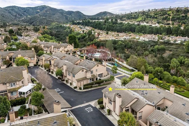 an aerial view of residential houses with outdoor space
