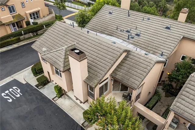 an aerial view of a house with a yard