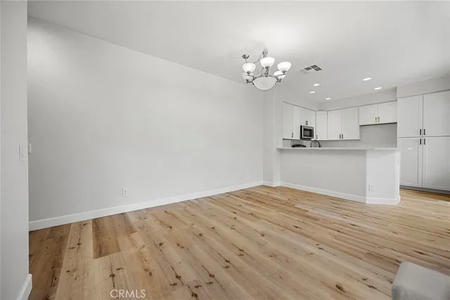 wooden floor in an empty room with a fireplace