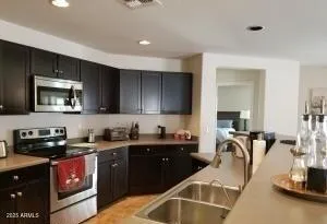 a kitchen with a sink and a refrigerator
