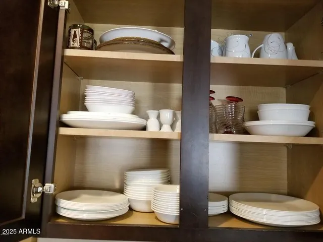 a shelf with cup and plates