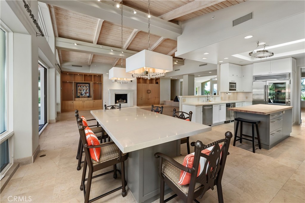6533 Lago Lindo Rancho Santa Fe, CA 92067 - Photo 22 of 57 a large kitchen with a table and chairs