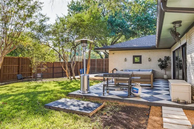 a view of a backyard with sitting area