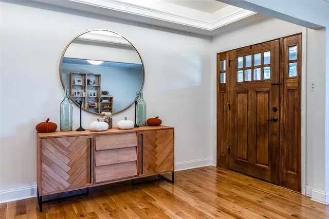 a view of a livingroom with wooden floor and cabinet