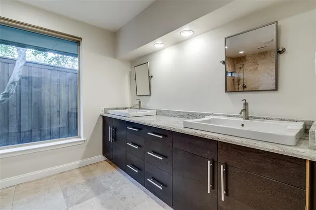 a bathroom with a double vanity sink and a mirror