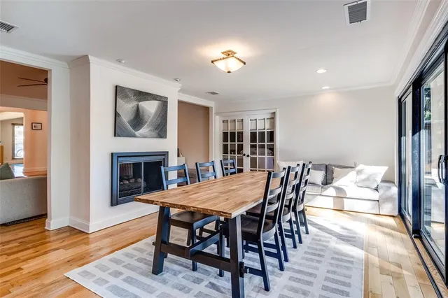 a view of a dining room with furniture wooden floor and a fireplace