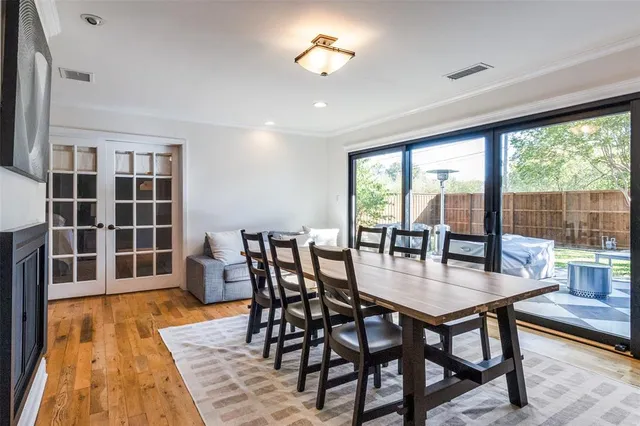 a dining room with furniture window and wooden floor