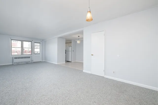 a view of an empty room with a closet