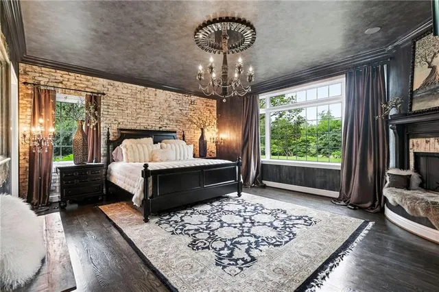 a bedroom with bed and wooden floor