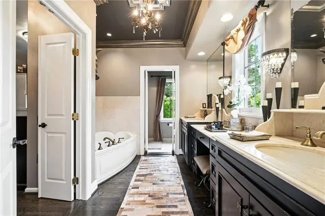 a bathroom with a granite countertop sink a mirror and a shower