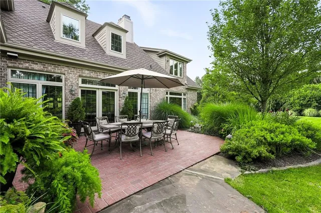 a view of a patio with chairs and plants
