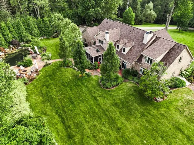 an aerial view of a house with garden space and street view