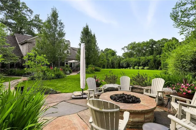 a backyard of a house with yard fountain and outdoor seating