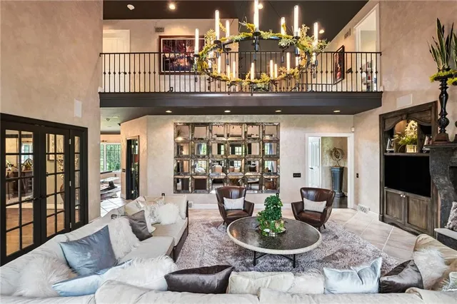 a living room with furniture and a floor to ceiling window