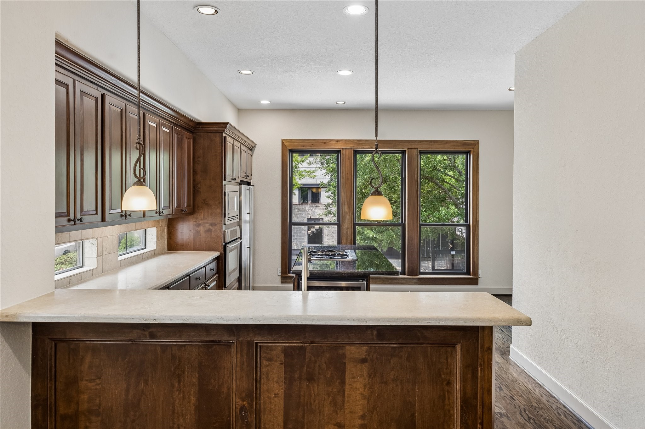 4301 Gibson Street Houston, TX 77007 - Photo 11 of 24 Chef's kitchen features stainless appliances, large island with gas cooktop, beverage refrigerator and additional seating, a breakfast area and large pantry!
