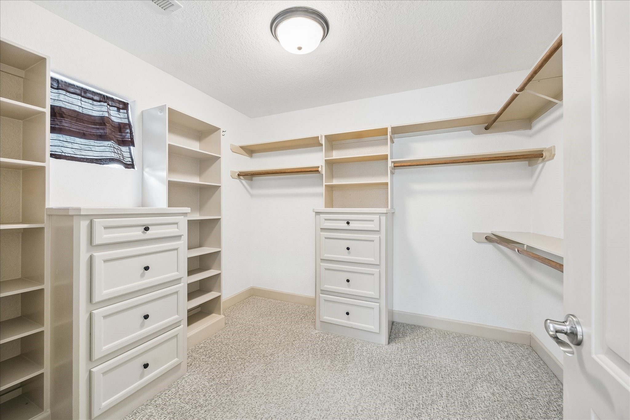 4301 Gibson Street Houston, TX 77007 - Photo 19 of 24 Primary closet with built-in dressers and shelving.