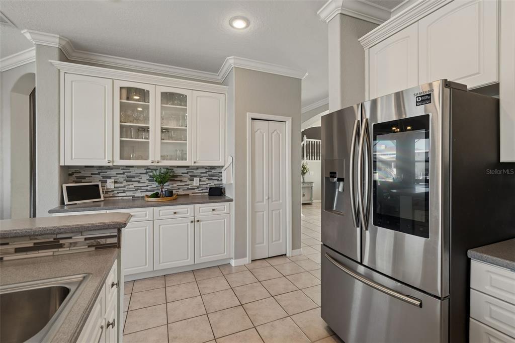 703 Bunker View Drive Apollo Beach, FL 33572 - Photo 12 of 49 a kitchen with stainless steel appliances a refrigerator sink and cabinets