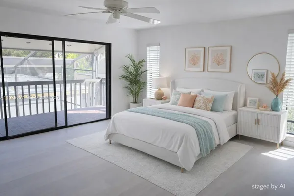 a spacious bedroom with a large bed and a chandelier