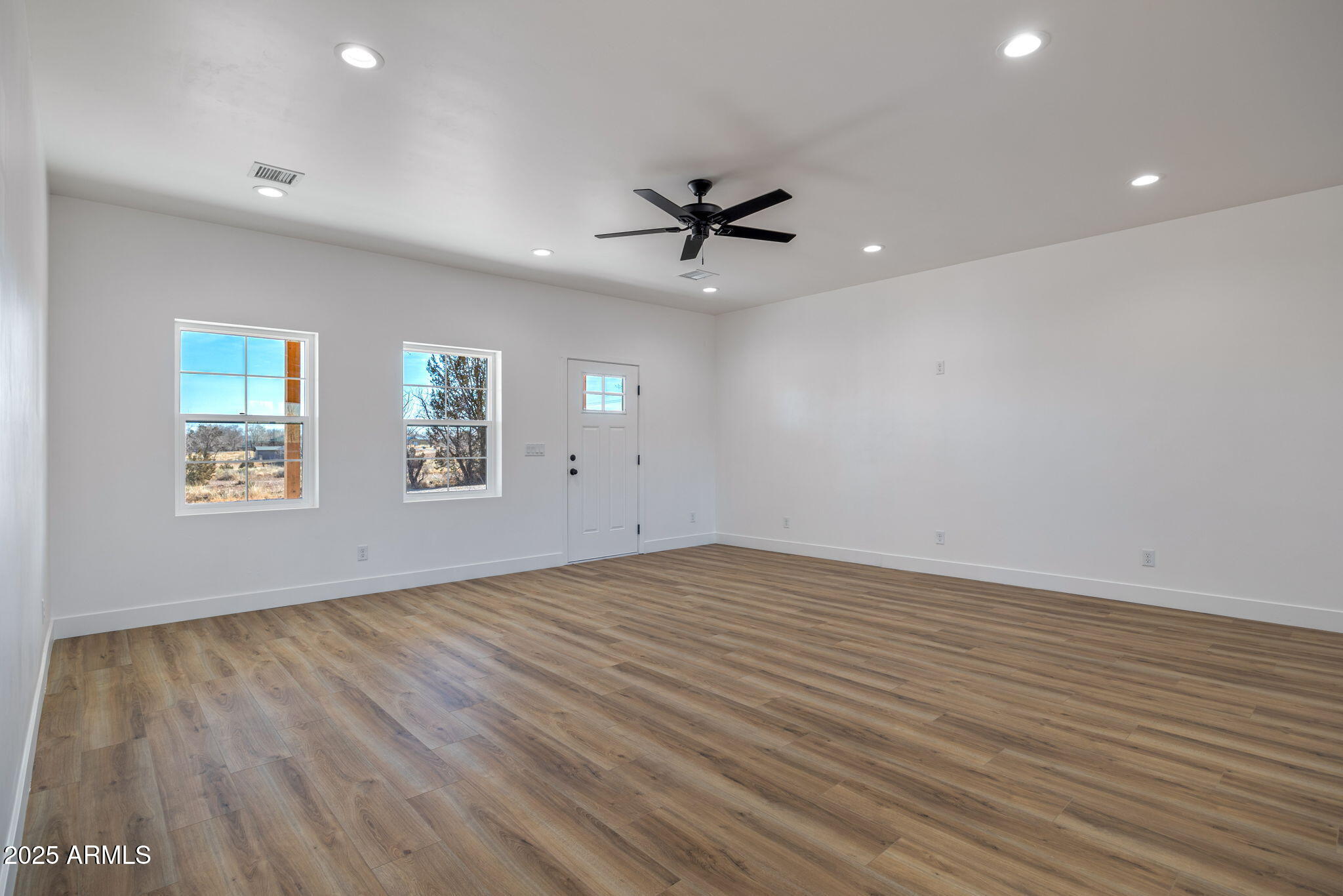855 10th South St. Johns, AZ 85936 - Photo 13 of 41 wooden floor in an empty room with a window