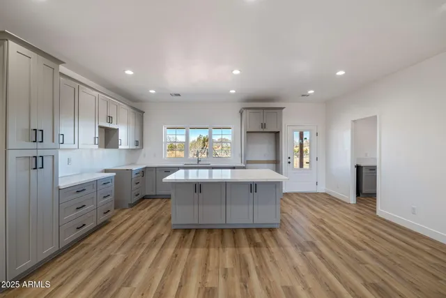 a kitchen with stainless steel appliances granite countertop a sink and wooden cabinets