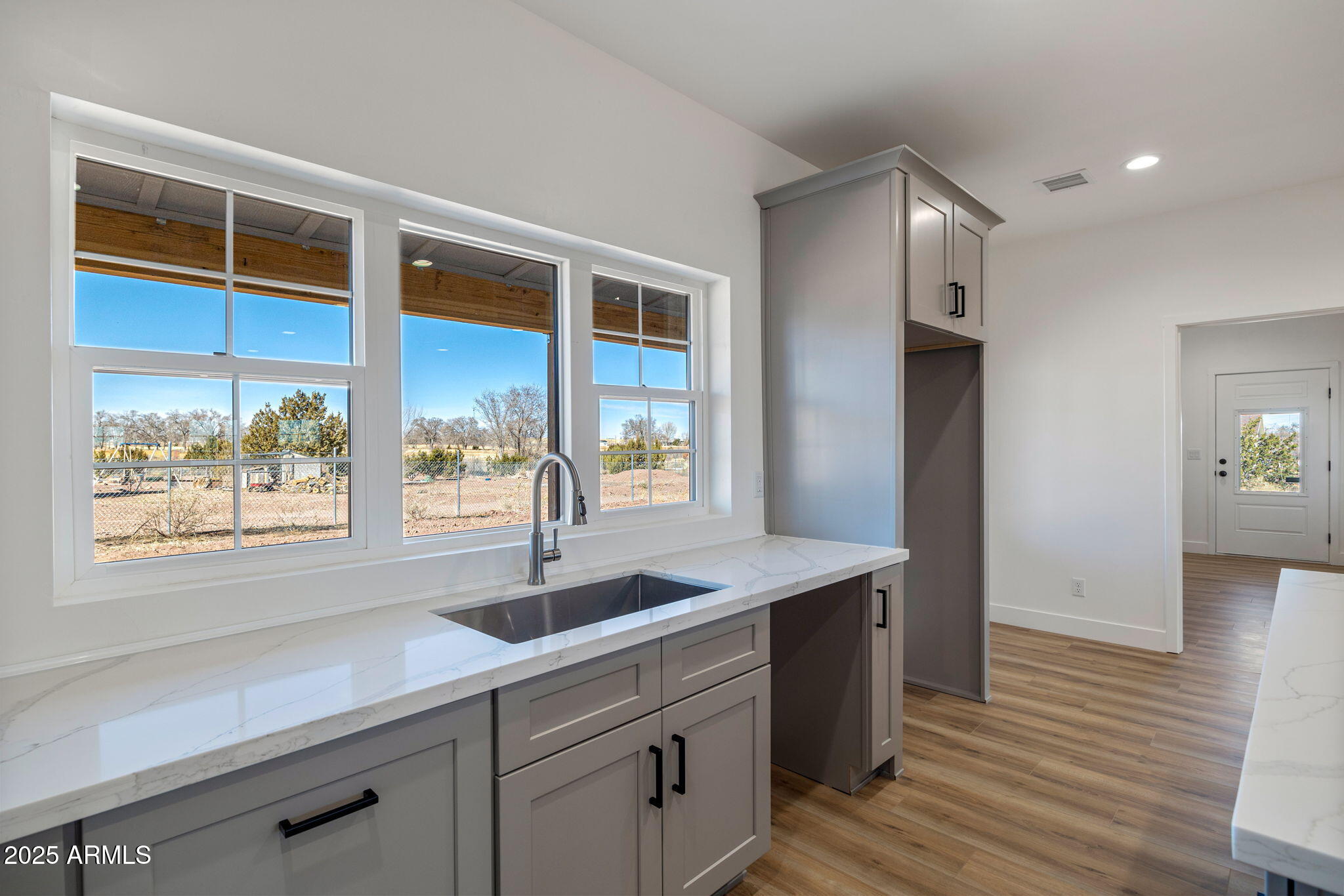 855 10th South St. Johns, AZ 85936 - Photo 16 of 41 a kitchen with stainless steel appliances granite countertop a sink and wooden cabinets