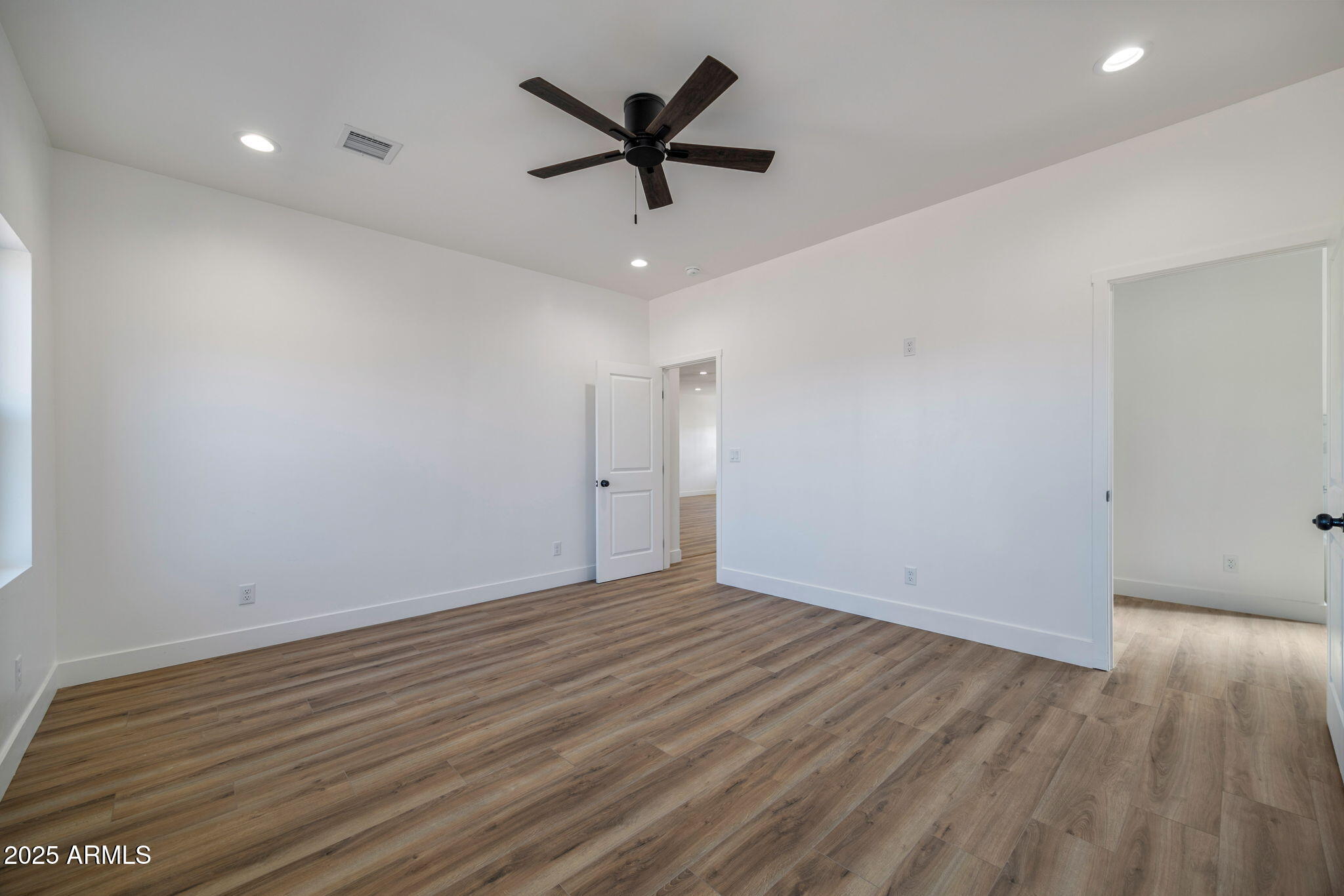 855 10th South St. Johns, AZ 85936 - Photo 20 of 41 an empty room with wooden floor and ceiling fan