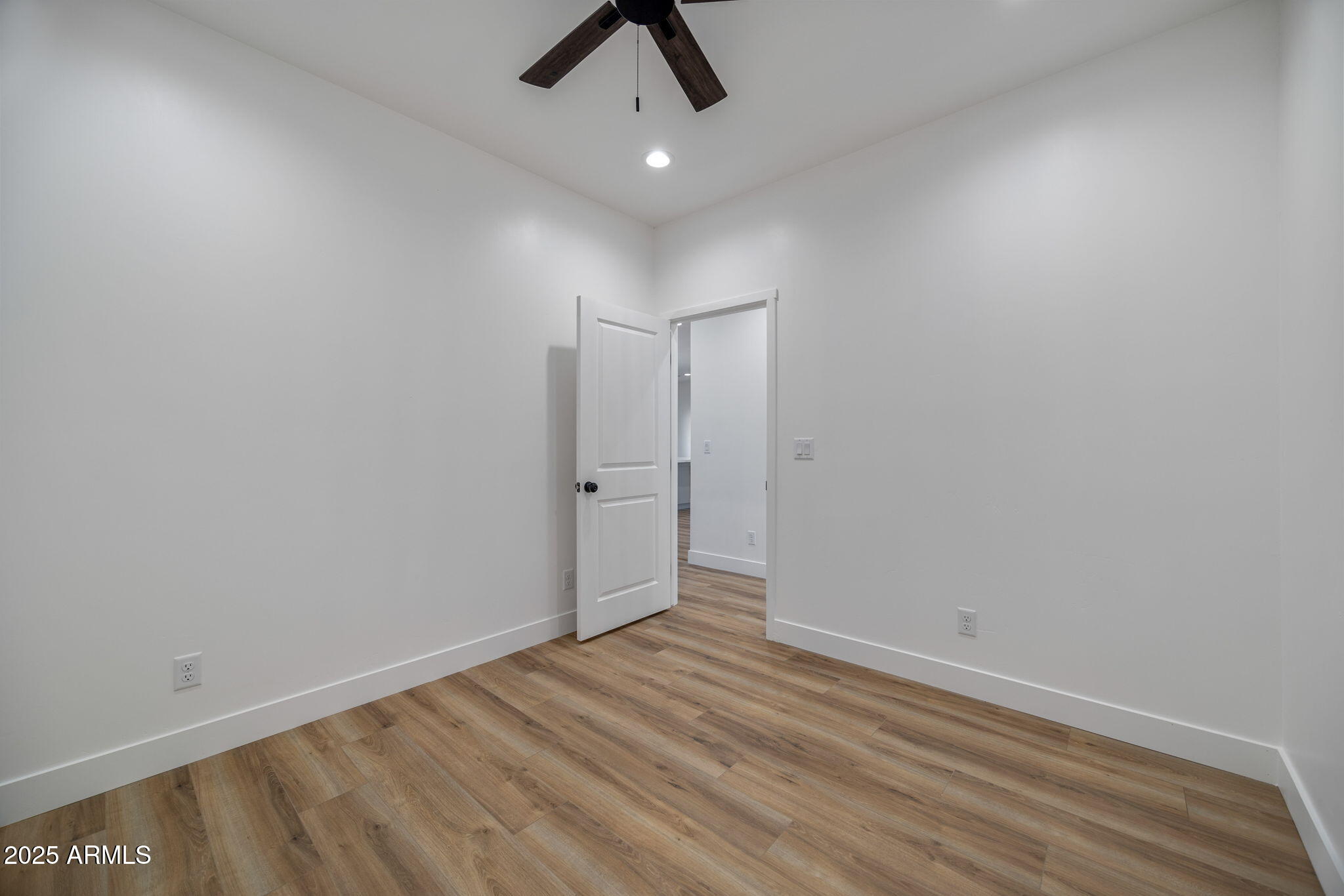 855 10th South St. Johns, AZ 85936 - Photo 24 of 41 an empty room with a ceiling fan and carpet