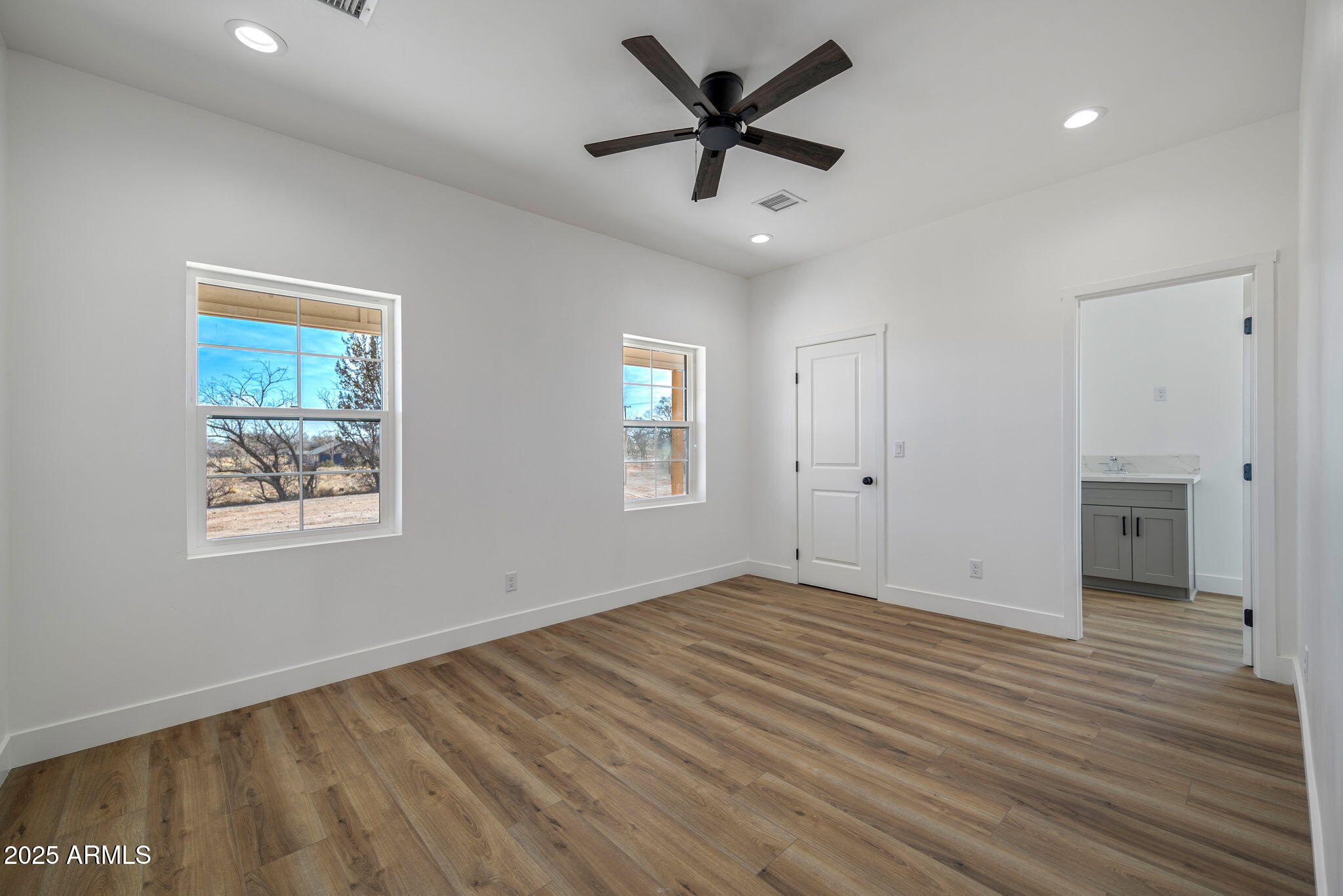 855 10th South St. Johns, AZ 85936 - Photo 25 of 41 a view of an empty room with a window and wooden floor