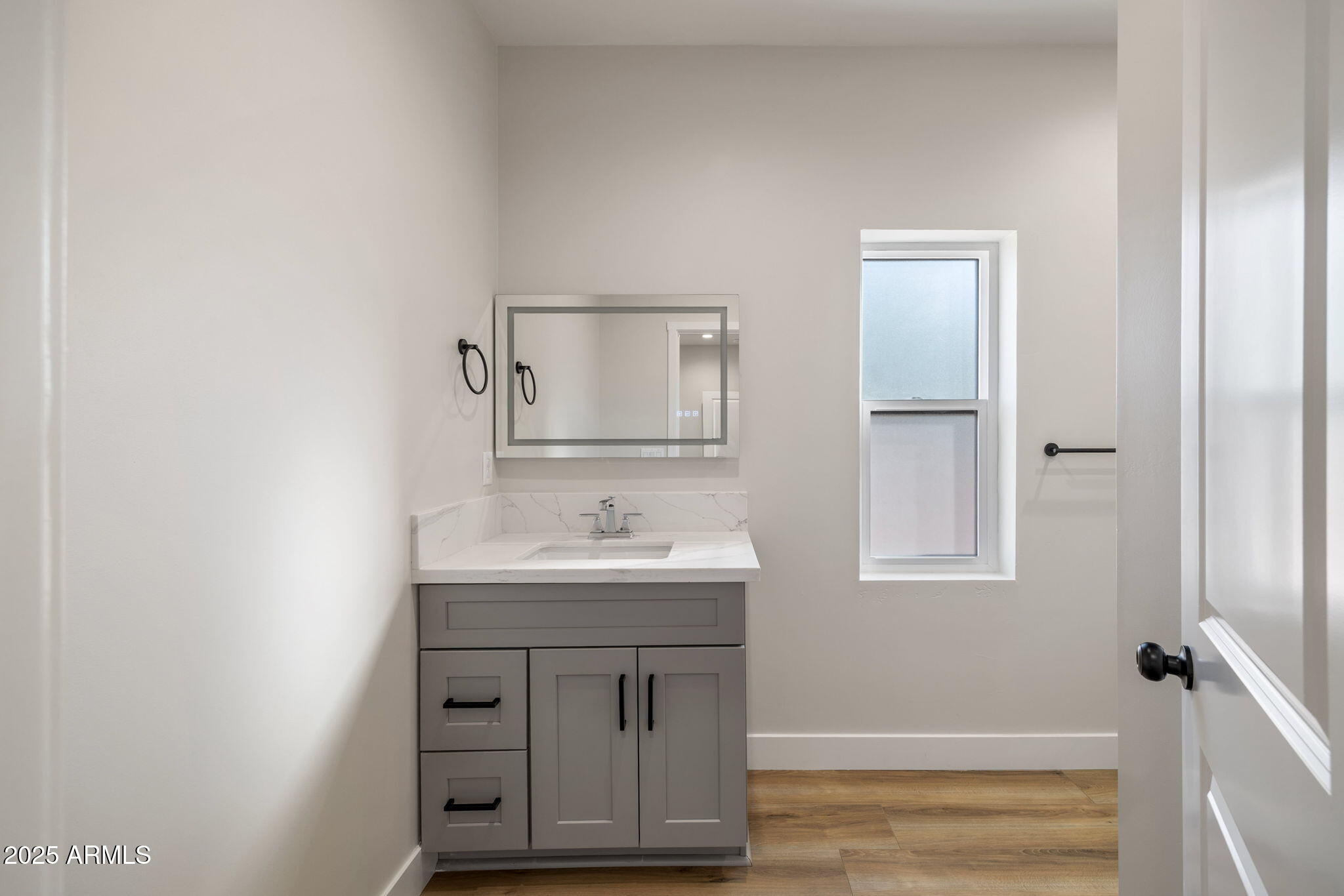 855 10th South St. Johns, AZ 85936 - Photo 27 of 41 a bathroom with a sink a mirror and vanity