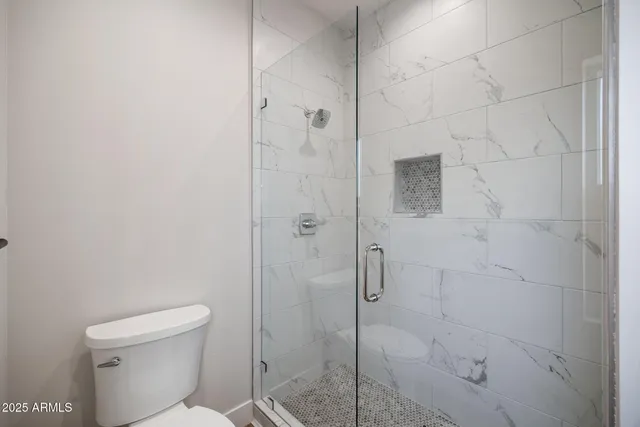 an empty room with a window and a ceiling fan